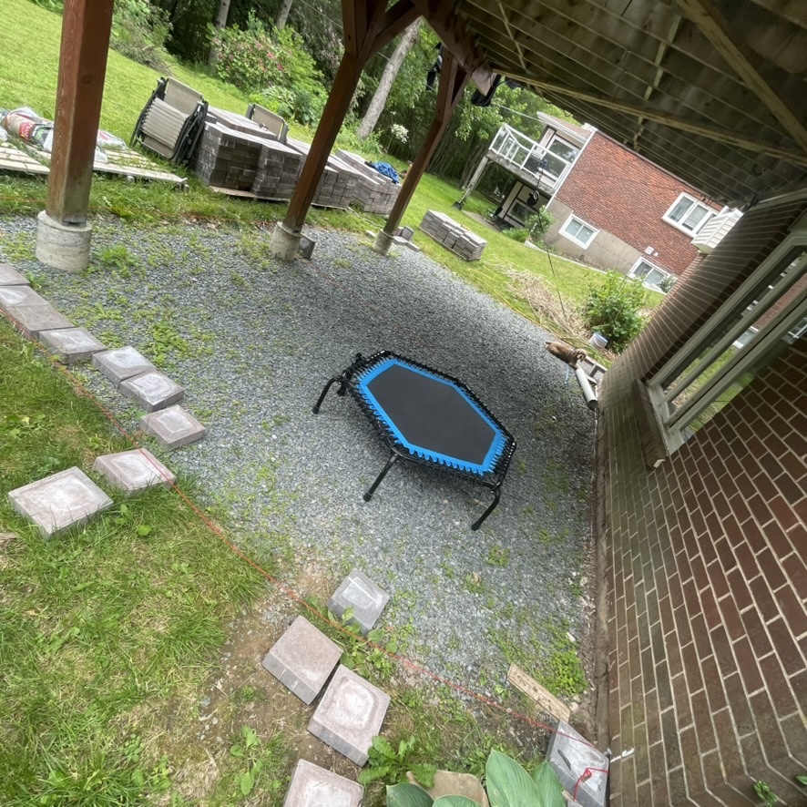 Gravel pad under the deck at 9 Wheatstone before the patio, with pavers stacked on pallets