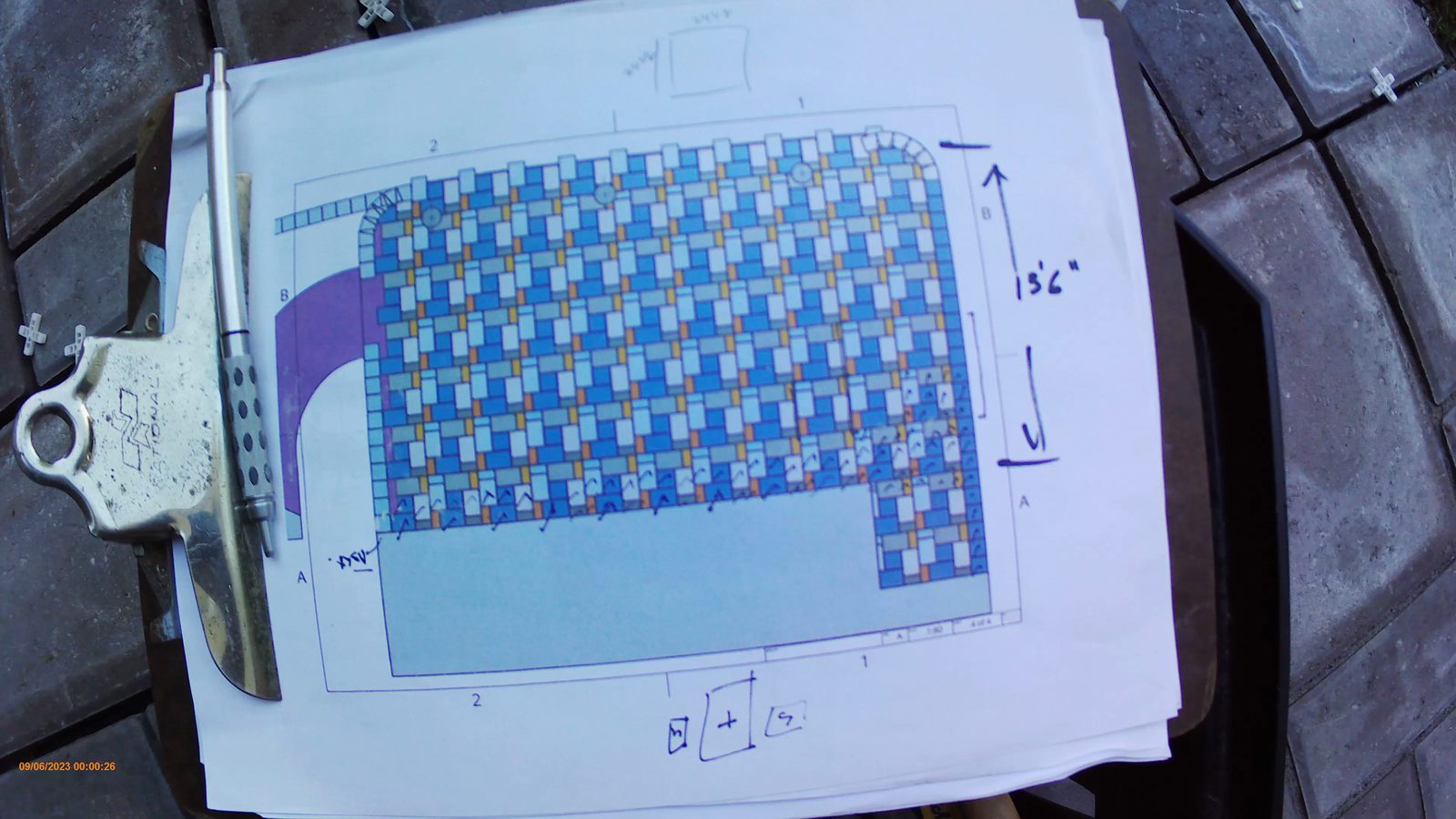 Printed patio pattern drawing clipped to a board on the job