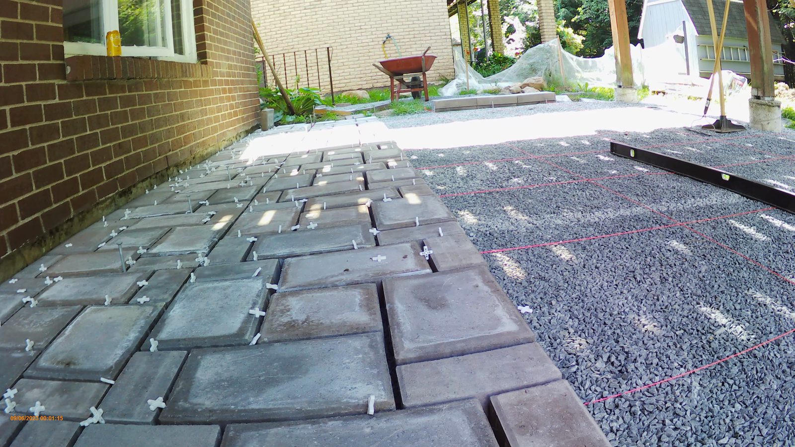 Pavers spreading across the base under the string grid